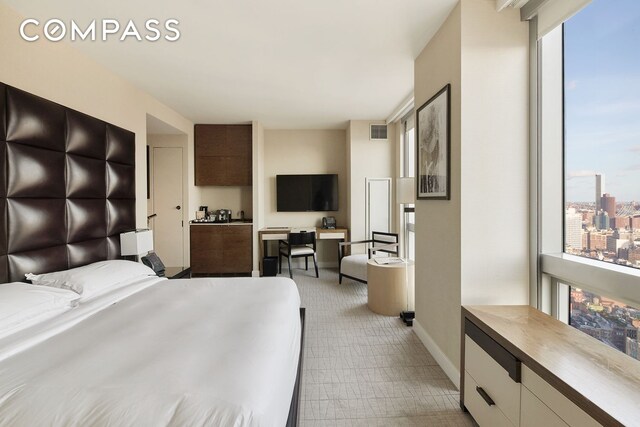 bedroom with multiple windows, baseboards, and visible vents