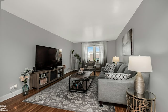 living area with wood finished floors and baseboards