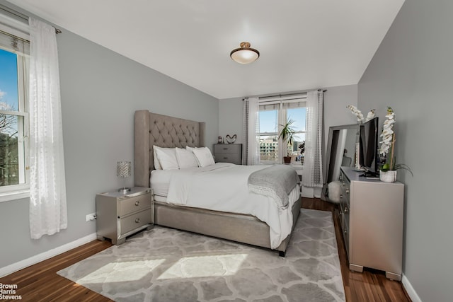 bedroom featuring wood finished floors and baseboards
