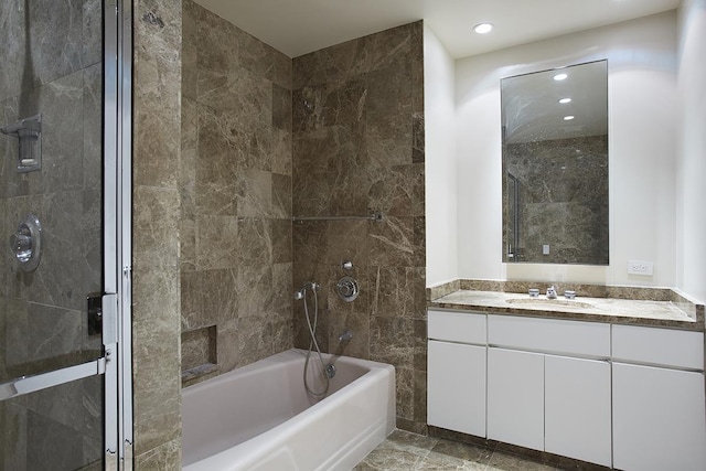 bathroom with shower / bathing tub combination, vanity, and recessed lighting