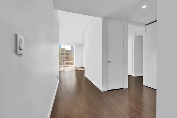 hall with recessed lighting, baseboards, and wood finished floors