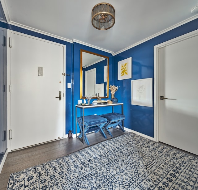 foyer entrance featuring ornamental molding and wood finished floors