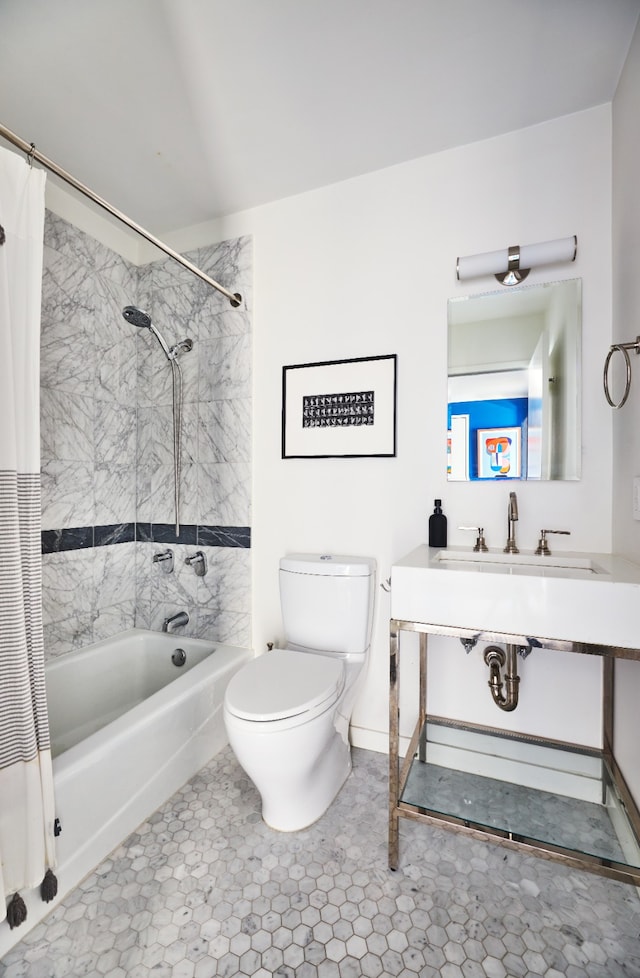 bathroom featuring vanity, shower / bath combo, and toilet