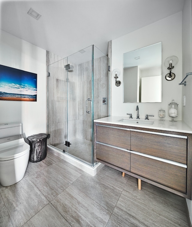 full bathroom featuring vanity, toilet, and a shower stall