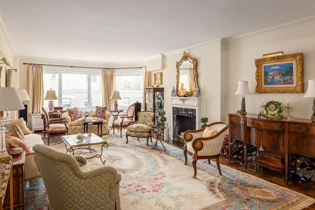 living room featuring a fireplace, crown molding, and wood finished floors