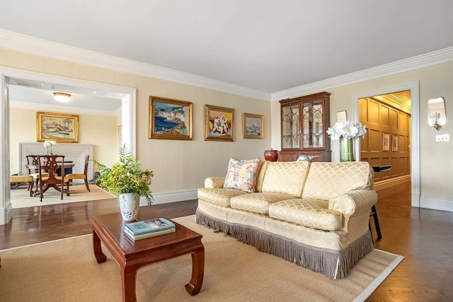 living area with ornamental molding, wood finished floors, and baseboards