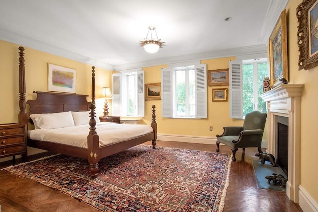 bedroom with a fireplace with flush hearth, multiple windows, crown molding, and baseboards