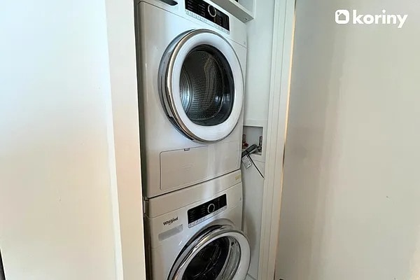 laundry room featuring laundry area and stacked washer / dryer