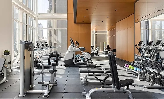 workout area with a wall of windows and wood ceiling