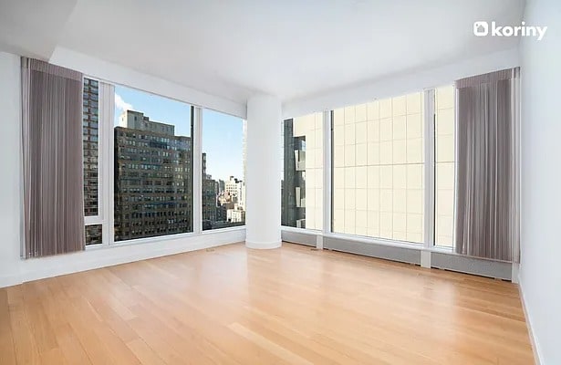 empty room with wood finished floors and a city view