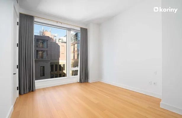 unfurnished room featuring baseboards and wood finished floors