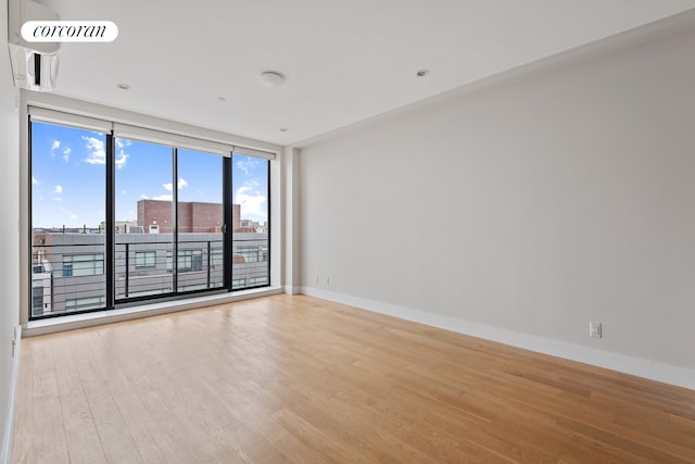 empty room featuring wood finished floors and baseboards