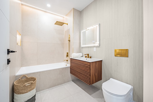 bathroom featuring tiled shower / bath combo, tile patterned flooring, toilet, and vanity