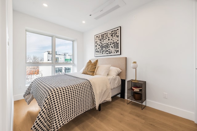 bedroom featuring recessed lighting, baseboards, and wood finished floors