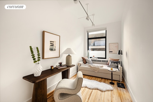 bedroom with wood finished floors, visible vents, and baseboards