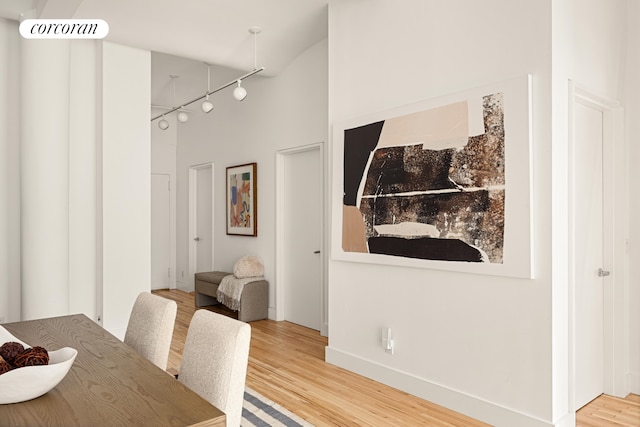 dining area with rail lighting, baseboards, visible vents, and wood finished floors