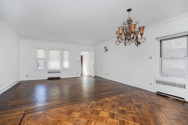 unfurnished living room with an inviting chandelier, crown molding, radiator, and baseboards