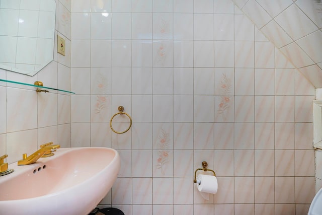 bathroom with tile walls and a sink