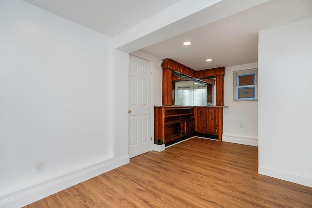 bar featuring recessed lighting, baseboards, and wood finished floors