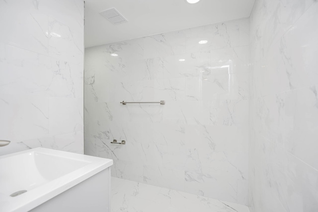 full bathroom with a marble finish shower, visible vents, marble finish floor, and tile walls