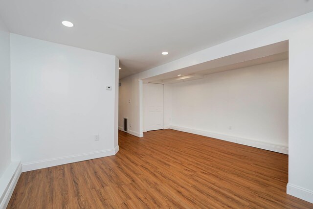 spare room featuring recessed lighting, visible vents, baseboards, and wood finished floors