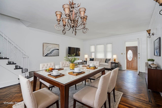 dining area featuring stairway, a notable chandelier, and ornamental molding