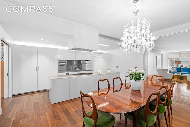 45 Crosby St Unit 6North, New York City, NY 10012 - dining space featuring light wood-style flooring, a chandelier, and crown molding