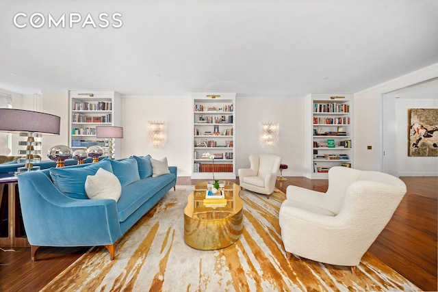 living area featuring built in shelves and wood finished floors