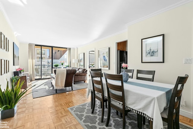 dining space with baseboards and ornamental molding