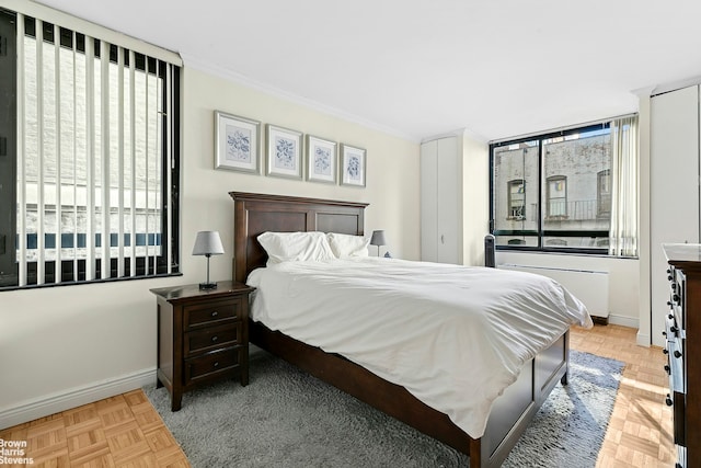 bedroom with baseboards and crown molding