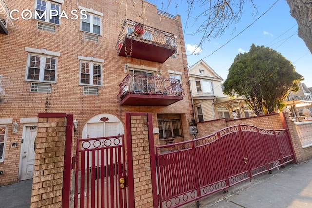 exterior space with fence and brick siding