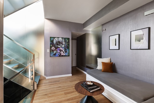 interior space with baseboards, stairway, and wood finished floors