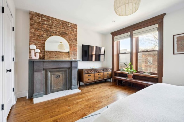 4 Agate Ct, New York City, NY 11213 - bedroom featuring light wood finished floors and a fireplace