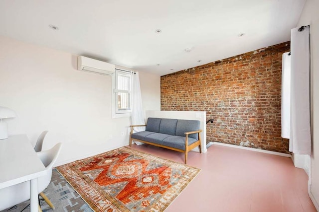 sitting room with brick wall, baseboards, and a wall mounted air conditioner