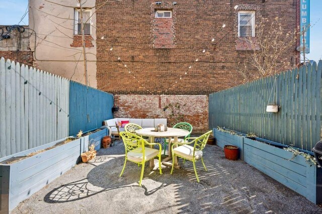 4 Agate Ct, New York City, NY 11213 - fenced backyard with a patio area and outdoor dining area
