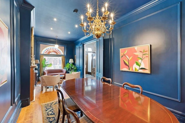 dining space with ornamental molding and wood finished floors