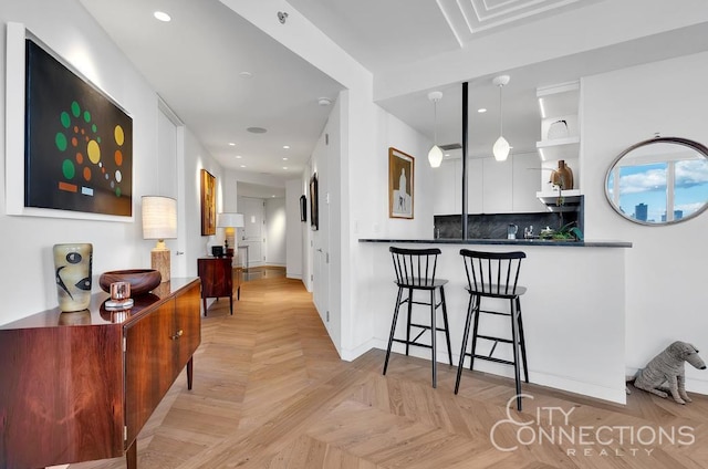 interior space featuring a breakfast bar area, recessed lighting, open shelves, tasteful backsplash, and decorative light fixtures