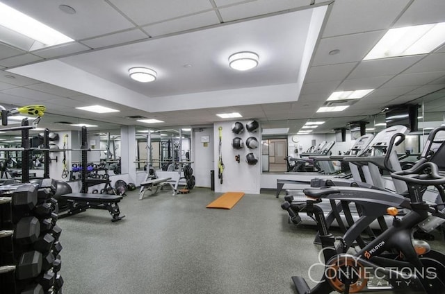 exercise room with a paneled ceiling
