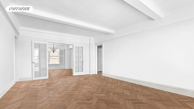 spare room with beamed ceiling, baseboards, an inviting chandelier, and visible vents