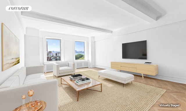 living area featuring baseboards, visible vents, radiator heating unit, and beam ceiling