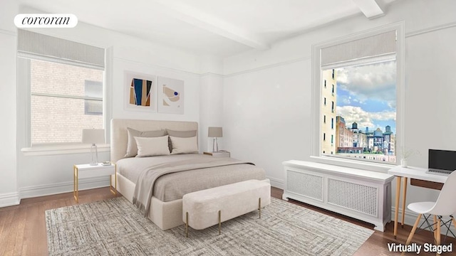 bedroom featuring radiator, baseboards, beam ceiling, and wood finished floors