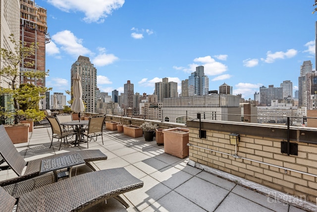 view of patio with a view of city and outdoor dining area