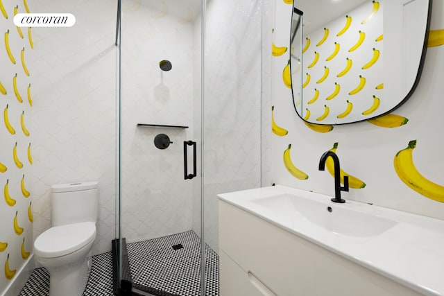 bathroom featuring a stall shower, vanity, and toilet