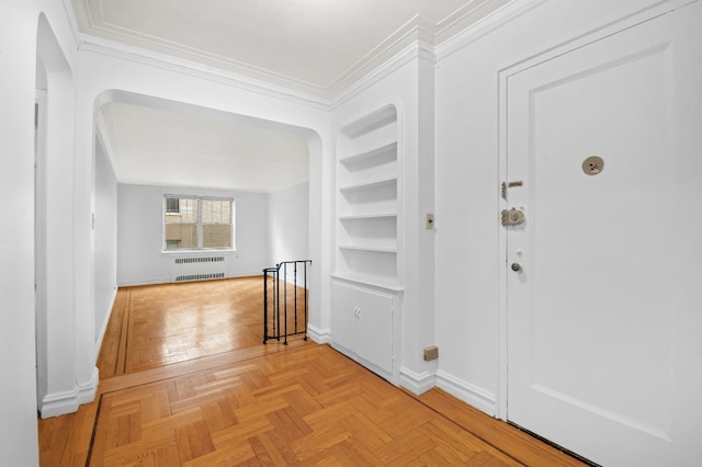hallway featuring radiator heating unit, crown molding, arched walkways, baseboards, and an upstairs landing