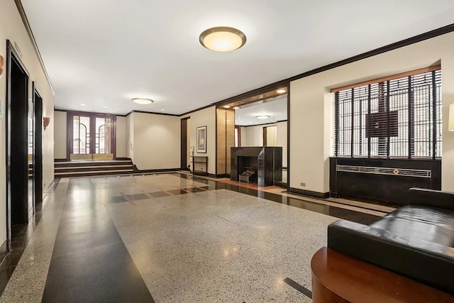 building lobby featuring crown molding and stairway
