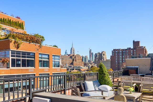 exterior space with an outdoor hangout area, a balcony, and a city view