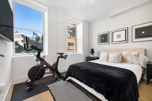 bedroom featuring baseboards and wood finished floors