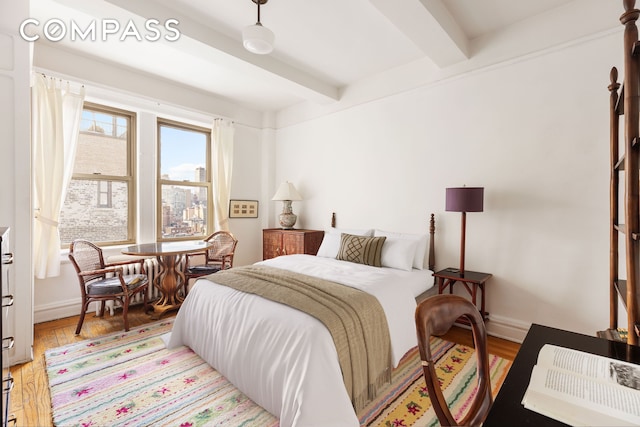 20 W 77th St Unit 15A, New York City, NY 10024 - bedroom with beamed ceiling, light wood-type flooring, and baseboards