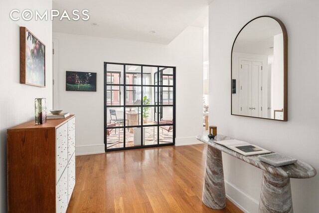 interior space with light wood-type flooring and baseboards