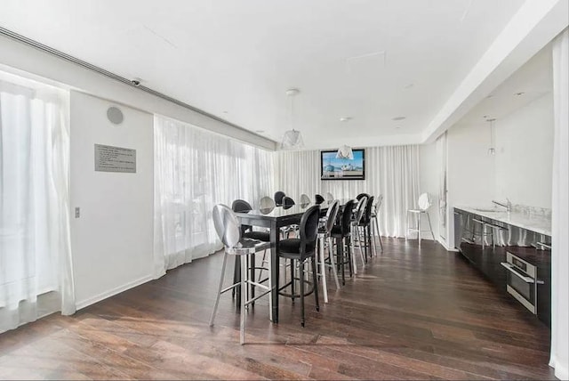 dining space featuring dark wood finished floors